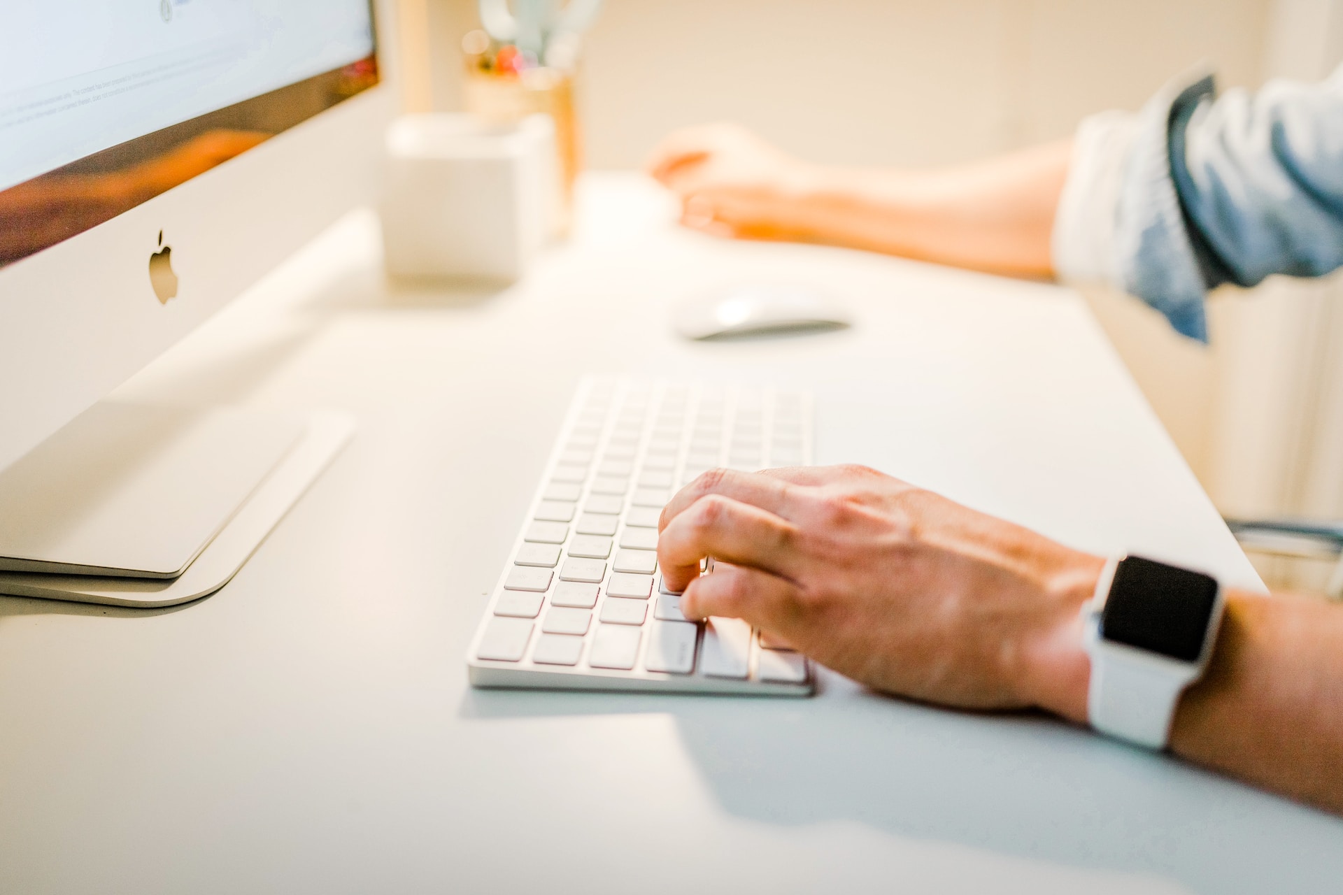 hand of a woman on computer keyboard, blogging with Showit